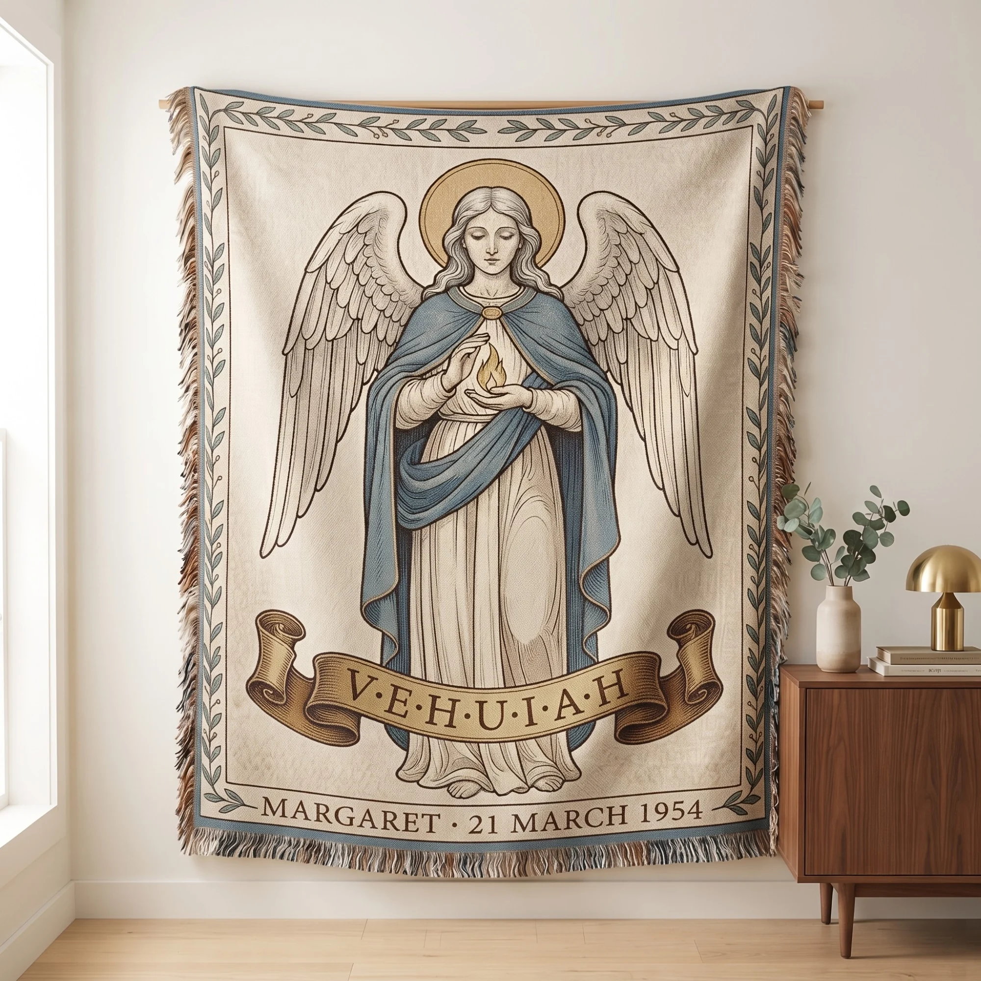Birth Angel Woven Blanket hanging from a wooden rod on a wall as a tapestry